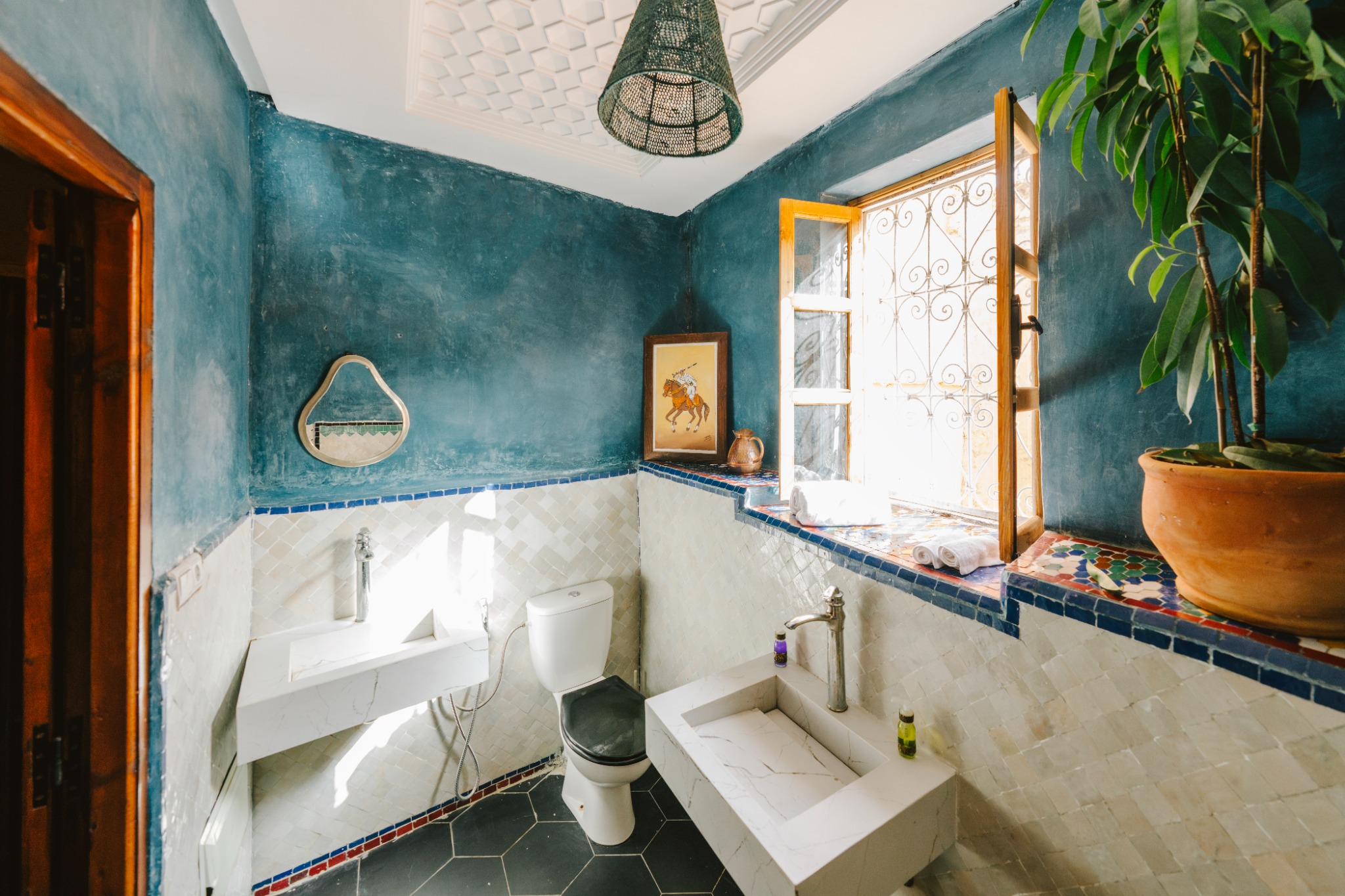 A deep blue bathroom with Moroccan tiles