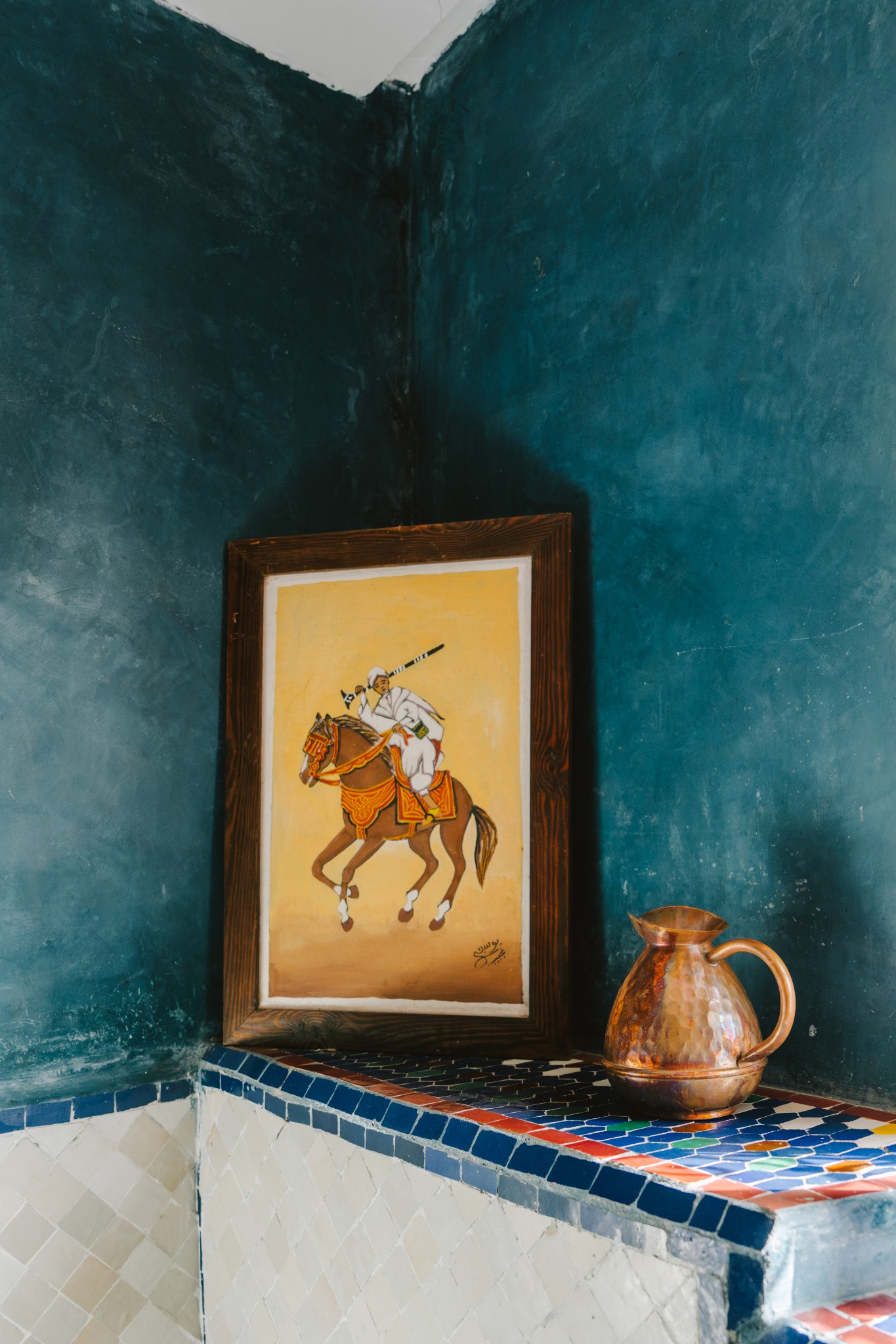 A hand-painted picture and copper jug in the riad