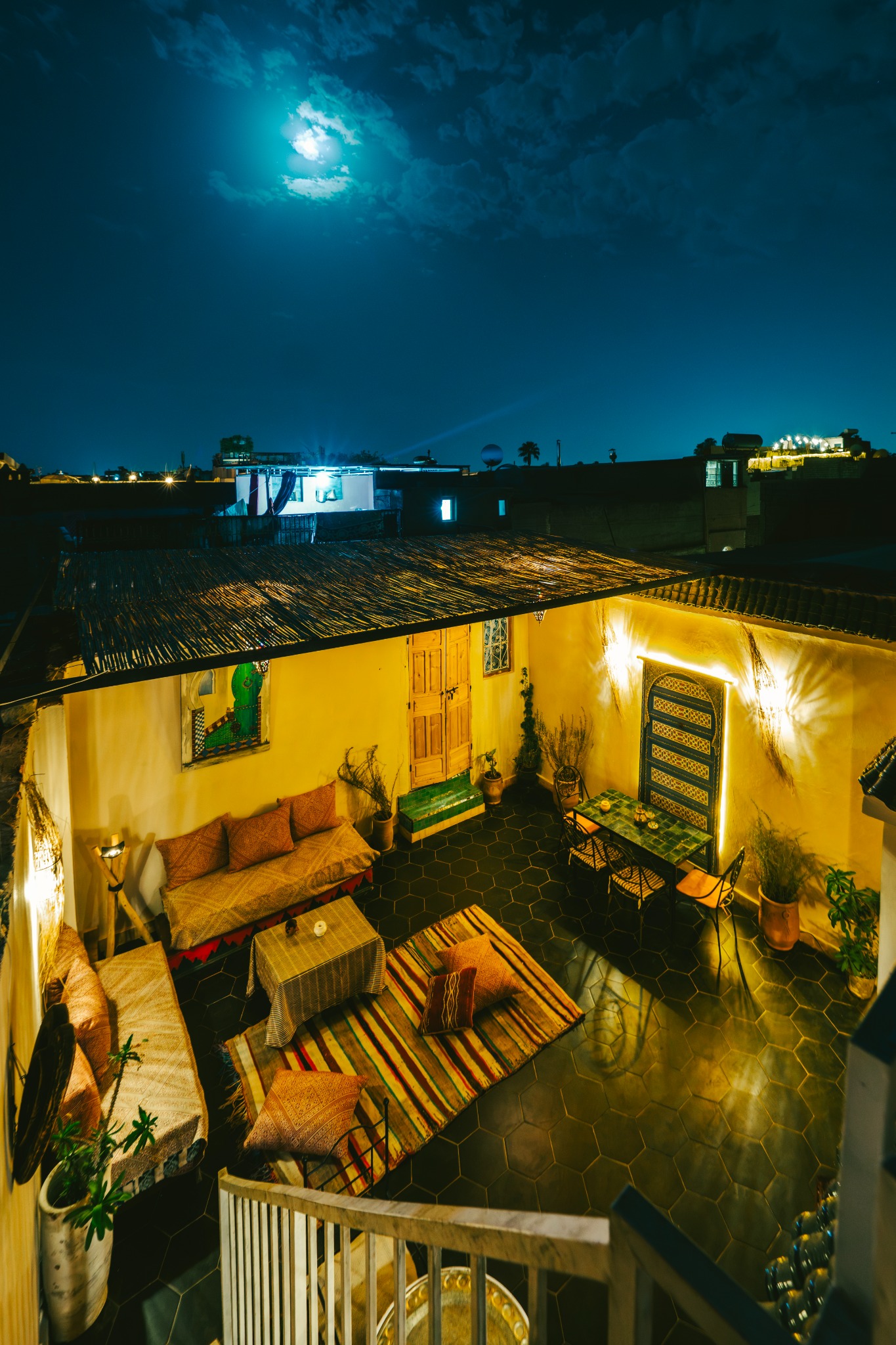 Moonlight above the warmly lit courtyard