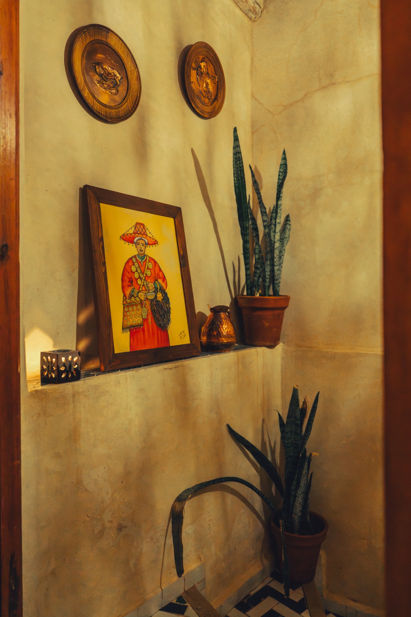 Plants and a hand-painted picture in warm light